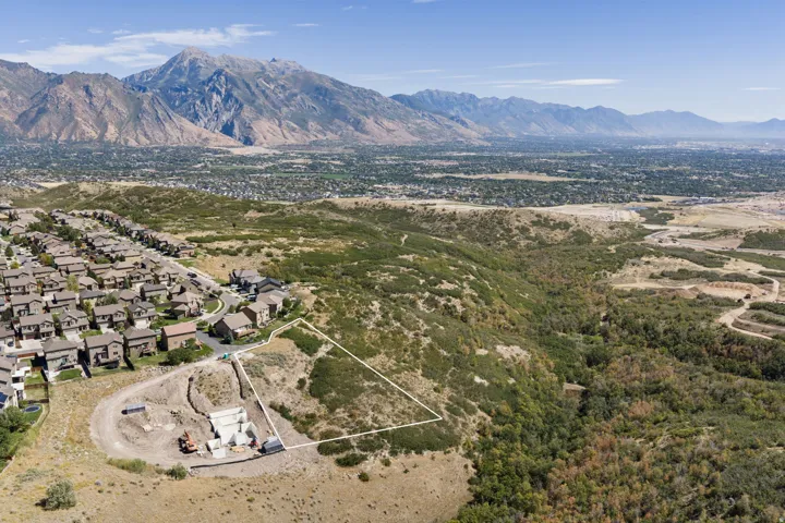 Expansive lot with mountain backdrop, surrounded by established residential development