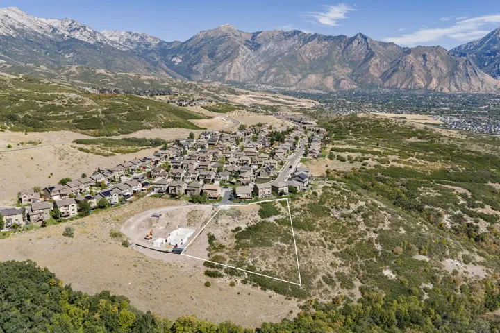 Expansive undeveloped lot featuring a natural, sloped terrain