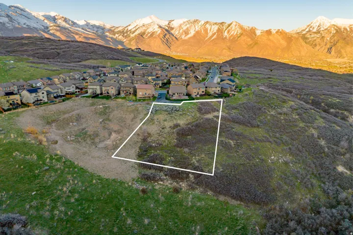 Expansive lot with surrounding neighborhood and mountain backdrop