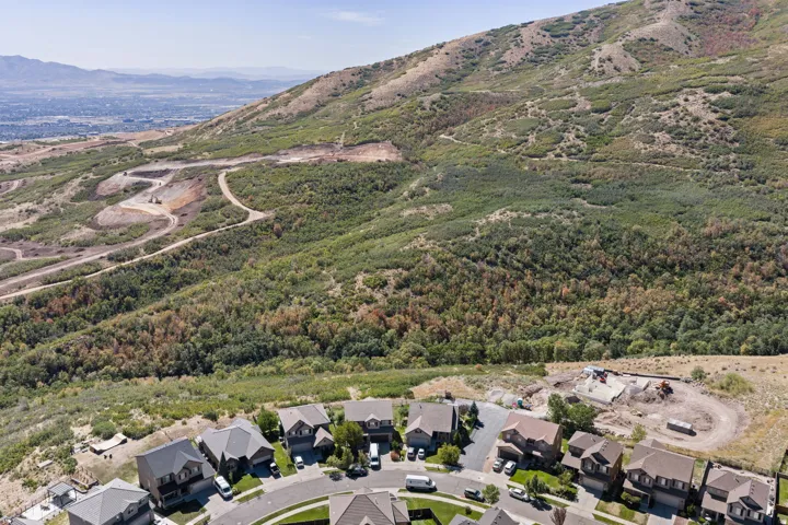 Residential neighborhood with established homes, undeveloped lots, and a mountain backdrop