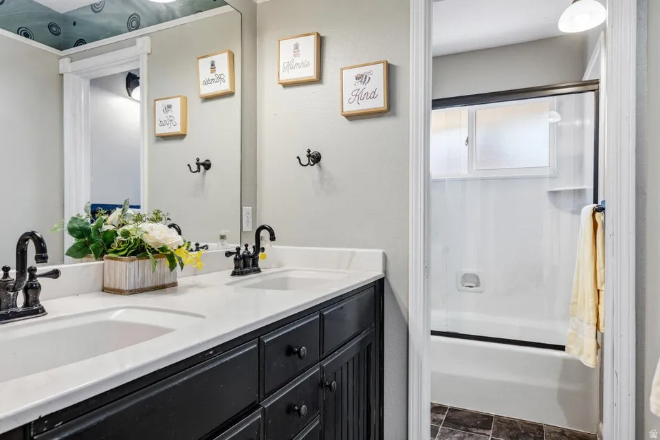 Dual vanity with dark cabinetry and white countertops