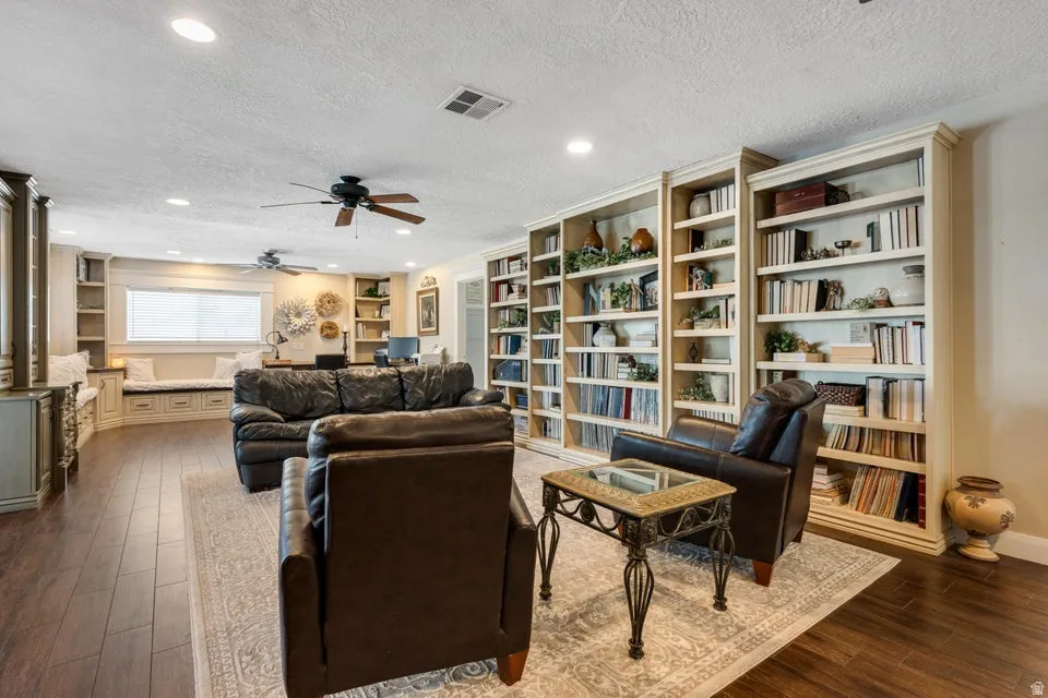 Wood-finish flooring, recessed lighting, built-in shelving, built-in window seating, and ceiling fans