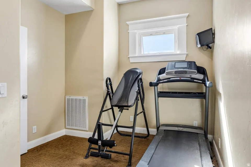 Compact room with a single window featuring decorative trim