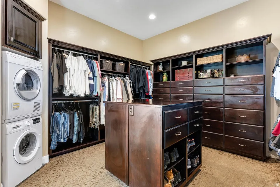 Custom closet system with dark wood-finish cabinetry, extensive shelving, and multiple drawers