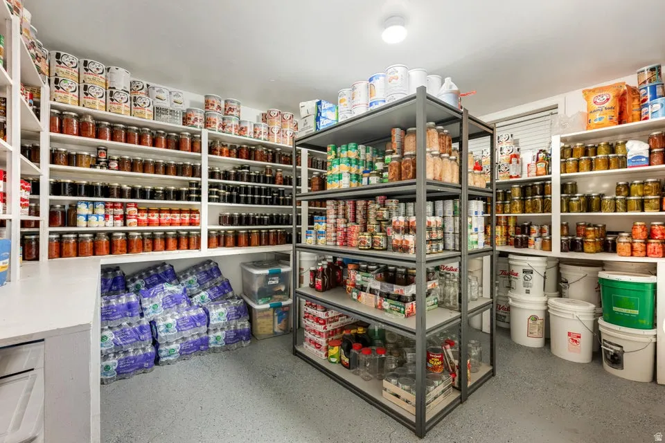 Custom built-in shelving, durable epoxy flooring, overhead flush-mount lighting, and robust metal shelving units