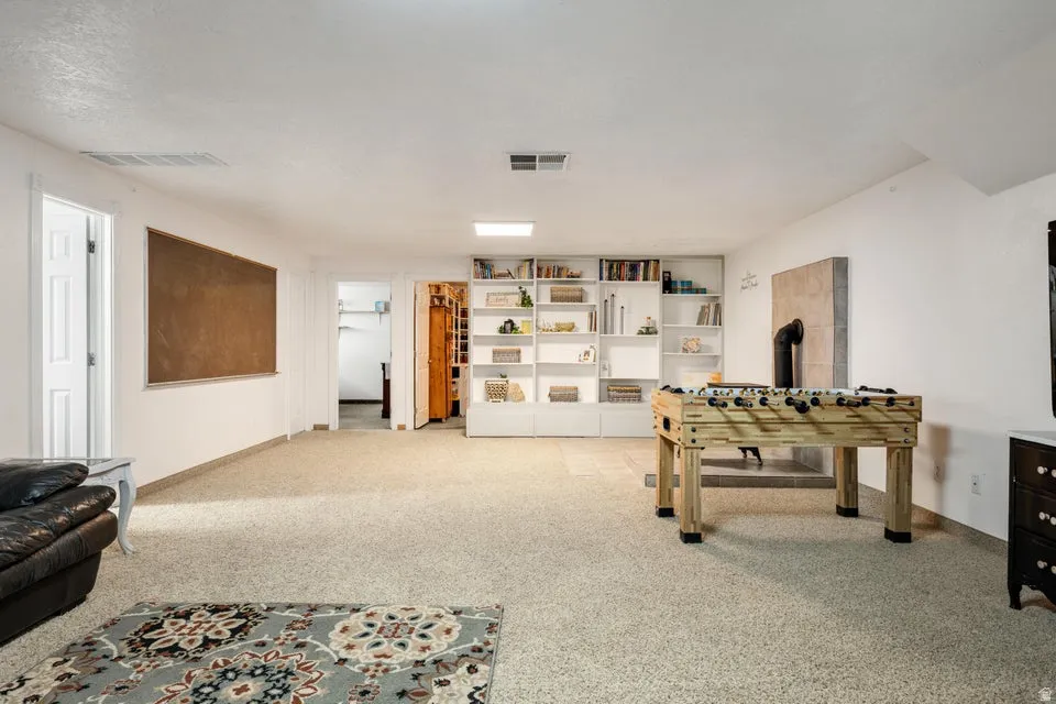 Built-in shelving, recessed lighting, and a hearth feature
