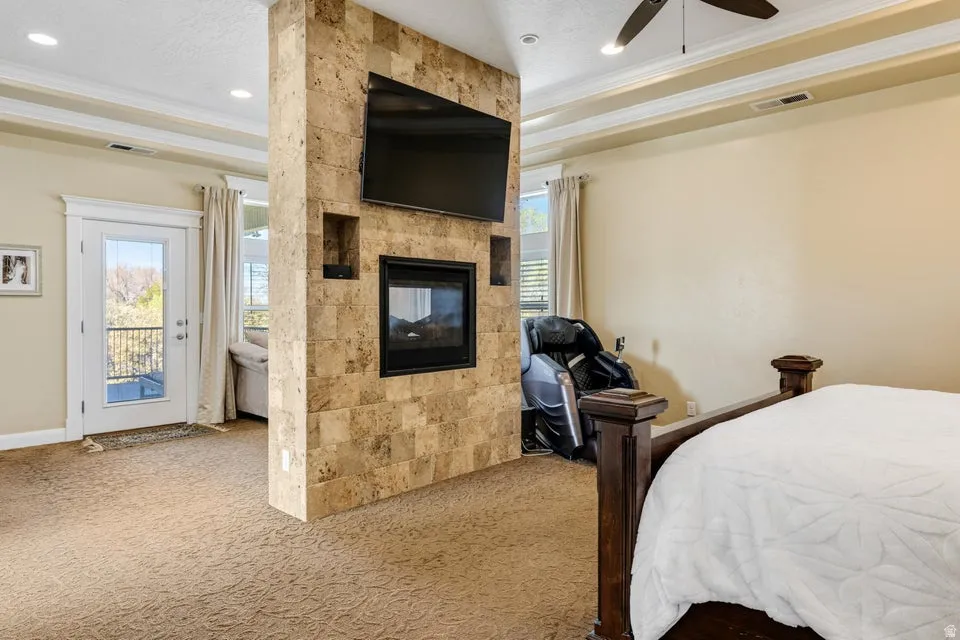 Floor-to-ceiling stone-clad fireplace with built-in shelving and an integrated electric firebox