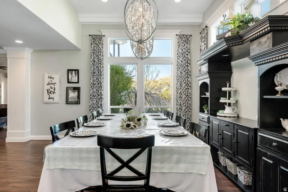 Recessed lighting, wood-finish flooring, built-in cabinetry, large windows, and decorative crown molding