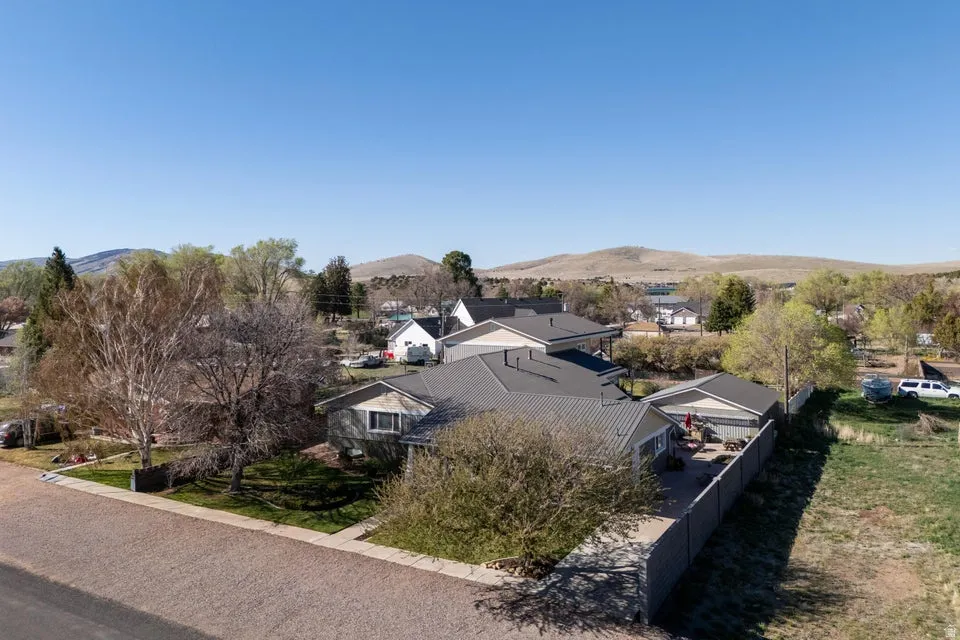 Property featuring a metal roof, fenced backyard, and established landscaping
