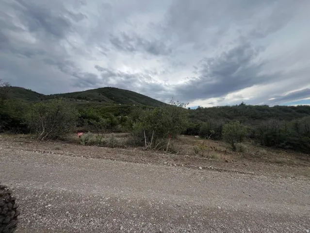 Gravel roadway with a natural, sloped terrain
