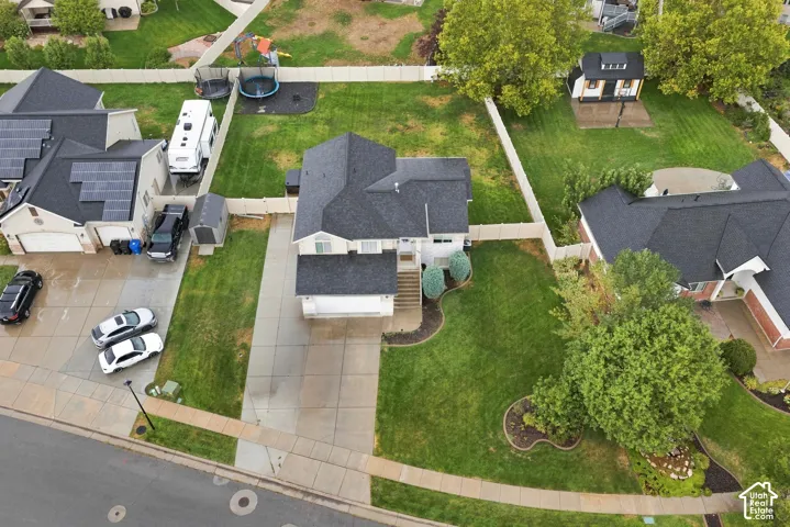 Two-story residence with an attached garage, paved driveway, and established landscaping
