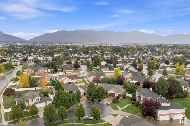 Residential neighborhood featuring paved streets and established landscaping, with a prominent mountain backdrop