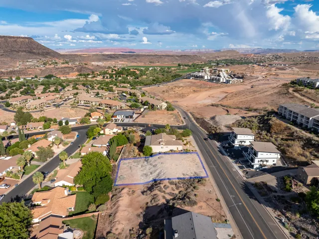 Expansive buildable lot with established neighboring residences, bordered by a paved roadway