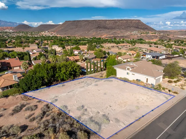 Expansive undeveloped lot with street frontage, surrounded by established residential properties
