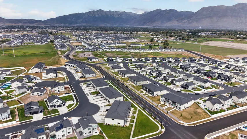 Aerial perspective of a developed residential community with a mountain backdrop.