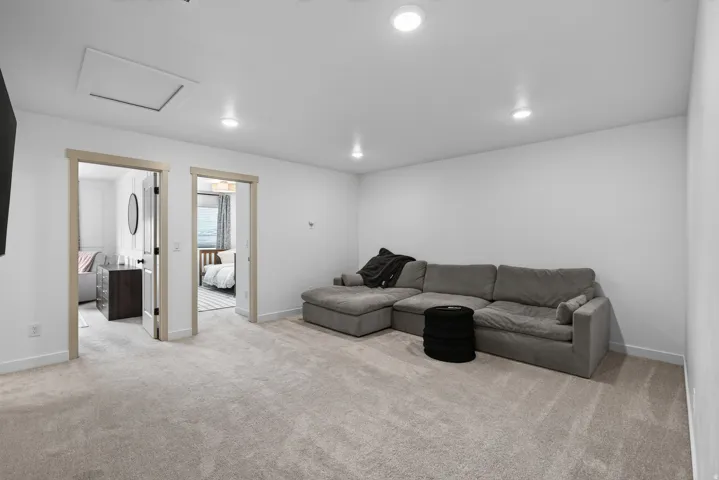 Upper level loft space Carpeted living area featuring recessed lighting, white walls, and light wood-finish door frames.