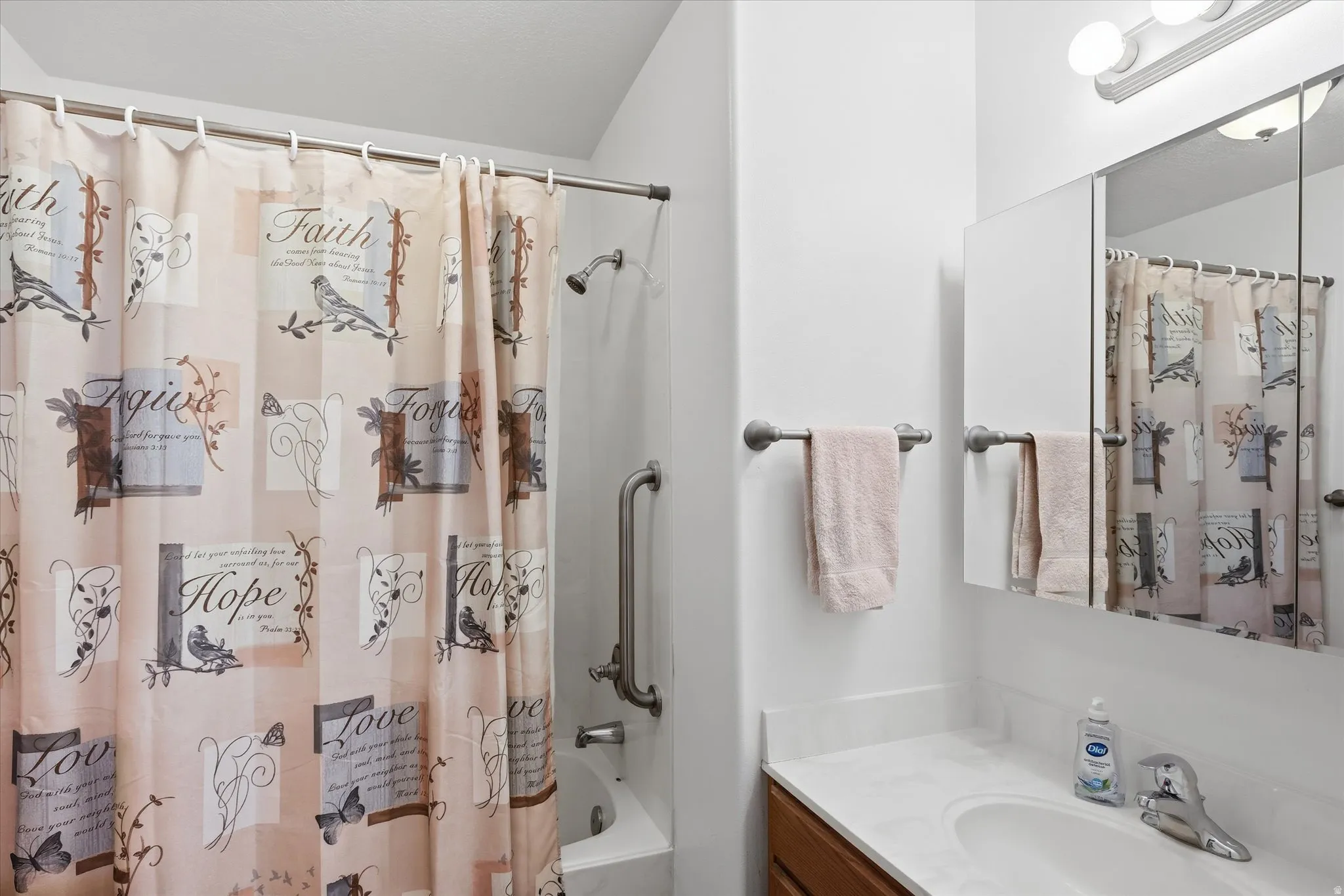 Tub and shower combination with grab bar