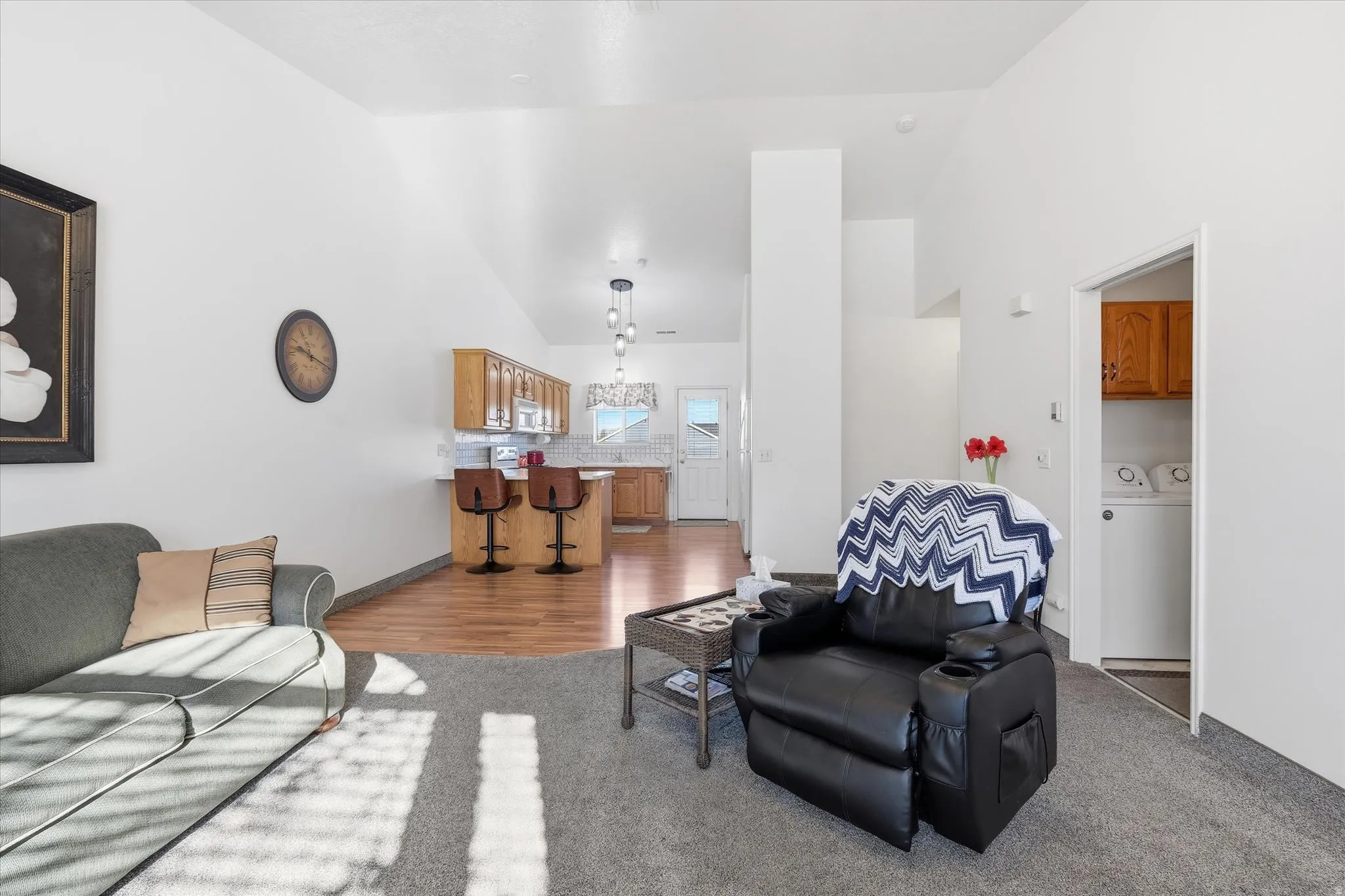 Vaulted ceilings over carpeted and wood-finish flooring