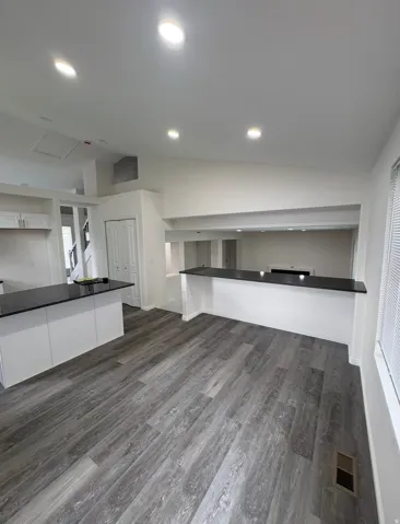 Wood-finish flooring throughout, complemented by recessed lighting