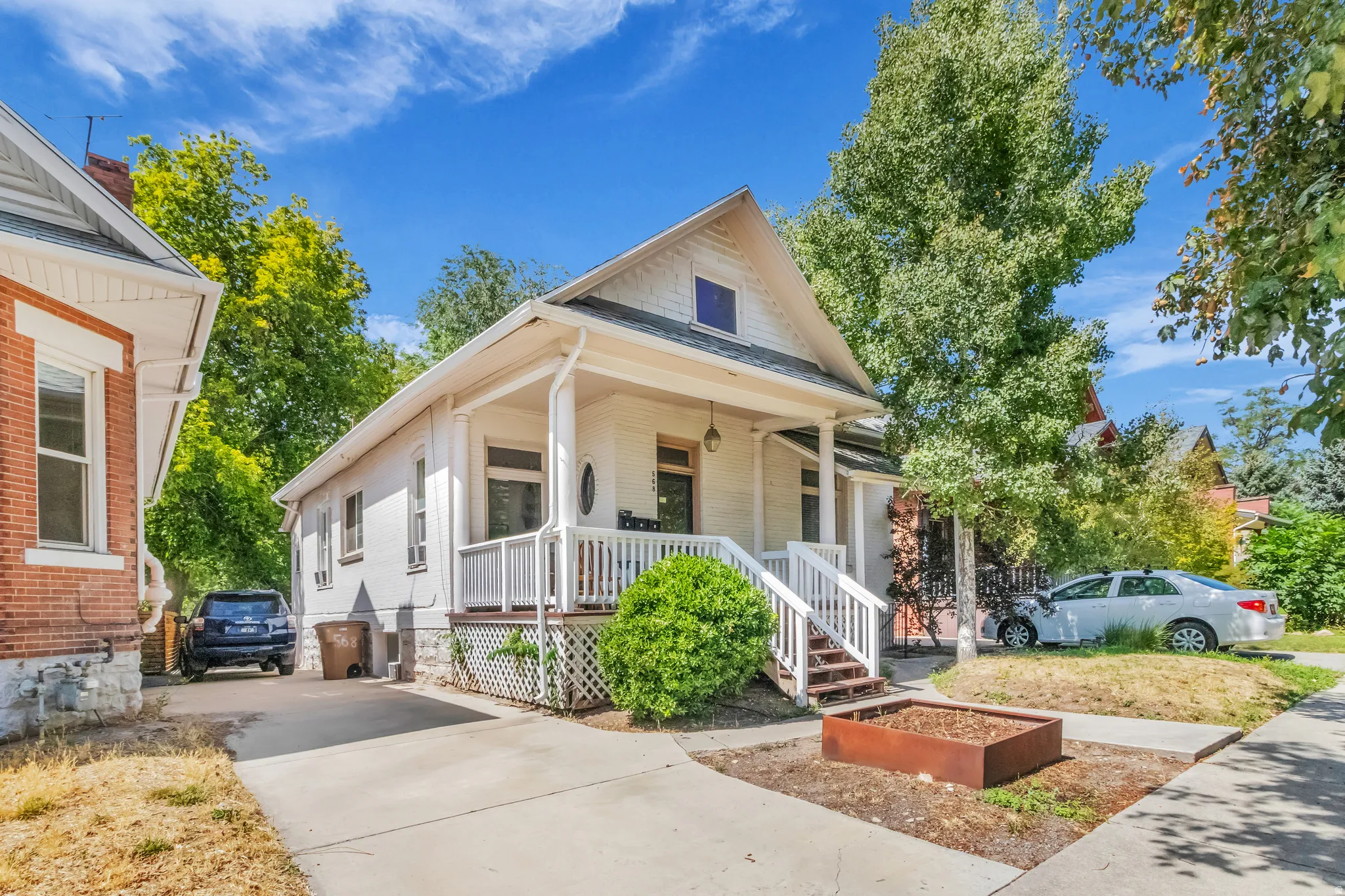 Traditional exterior with a covered porch, white railing, and columns