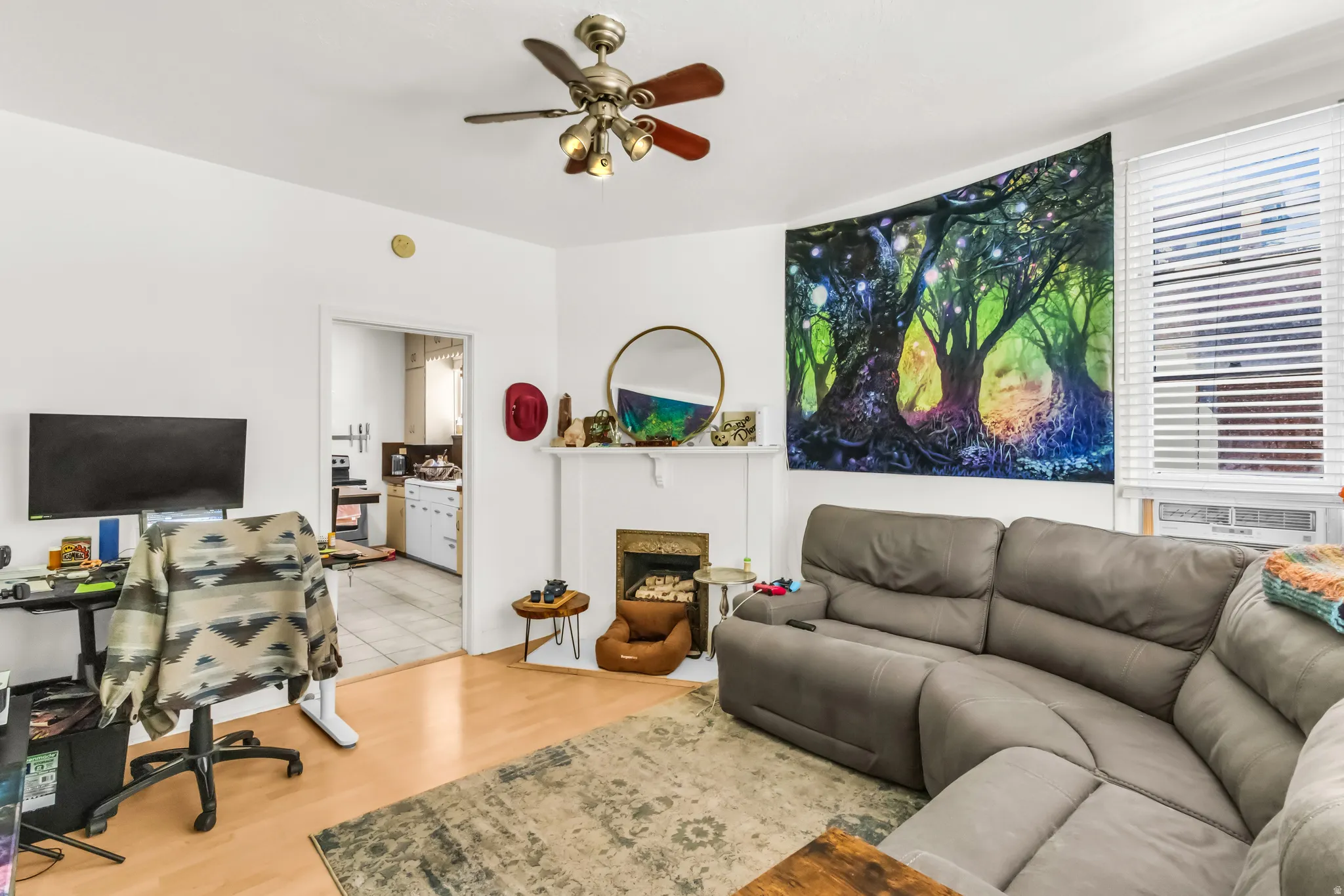 Wood-finish flooring with a ceiling fan light fixture
