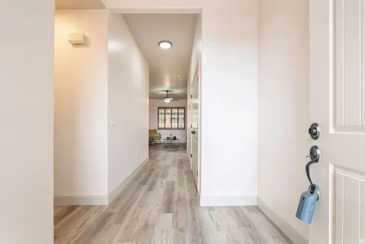 Entryway featuring wood-finish flooring, recessed lighting, and a paneled entry door with dark hardware