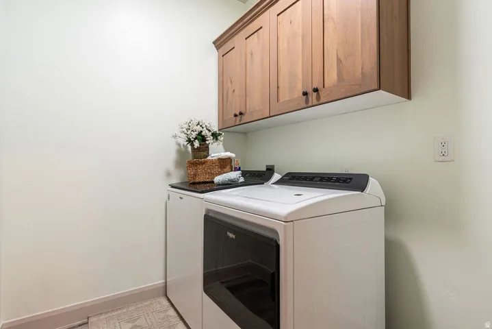Wood-finish upper cabinetry with dark hardware, alongside a dark countertop surface
