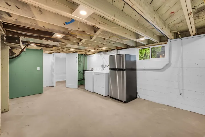 Basement utility space featuring recessed lighting, concrete flooring, and a window