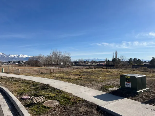Expansive undeveloped lot featuring clear land and a concrete pathway