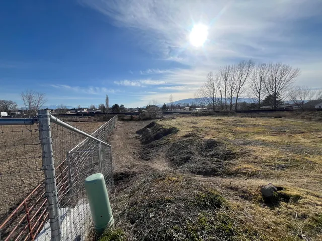 Expansive open lot with distant mountain scenery