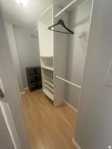 Built-in closet organization system with shelving, integrated shoe cubbies, and garment rods