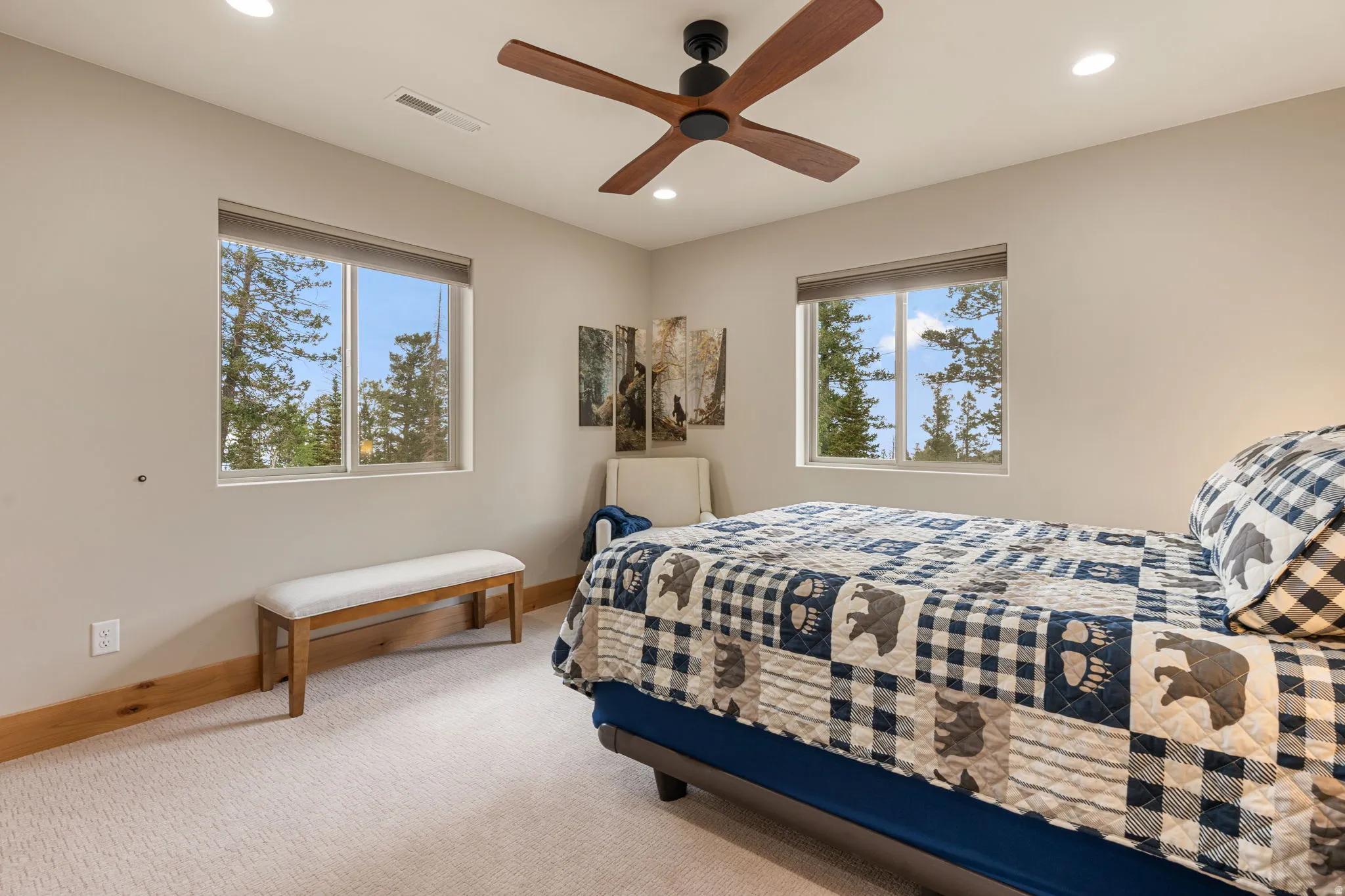 Recessed lighting, ceiling fan with wood-finish blades, two windows with roller shades, light-toned carpet, and wood-finish trim