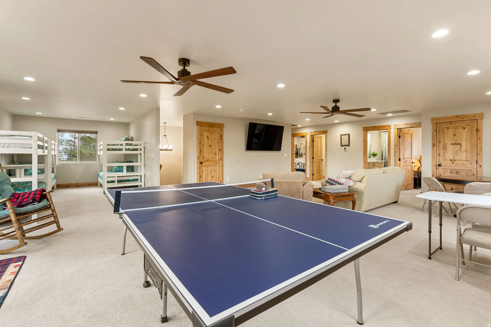 Expansive open-concept room with recessed lighting and two ceiling fans