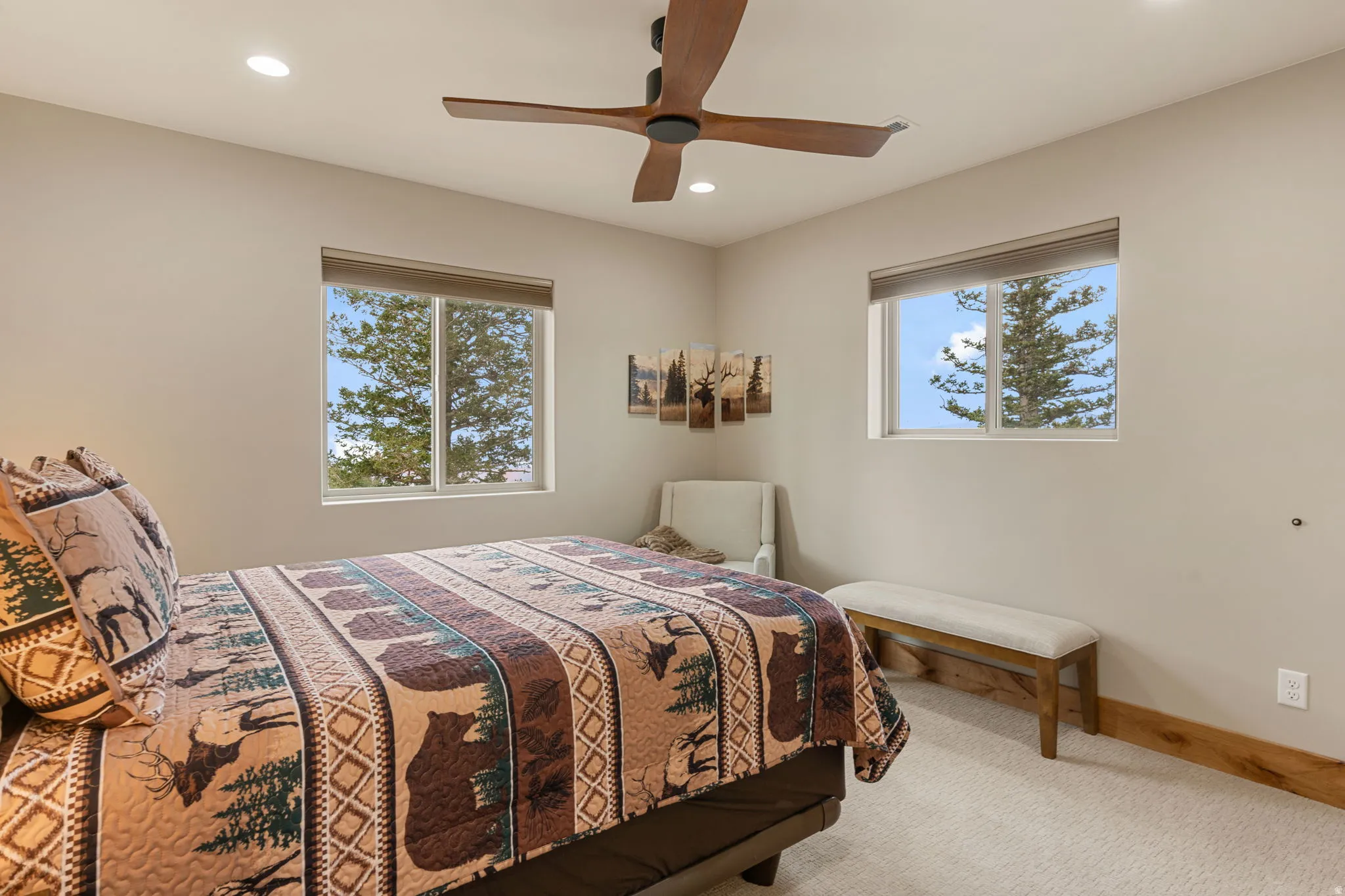 Recessed lighting, wood-finish ceiling fan, and two windows with roller shades