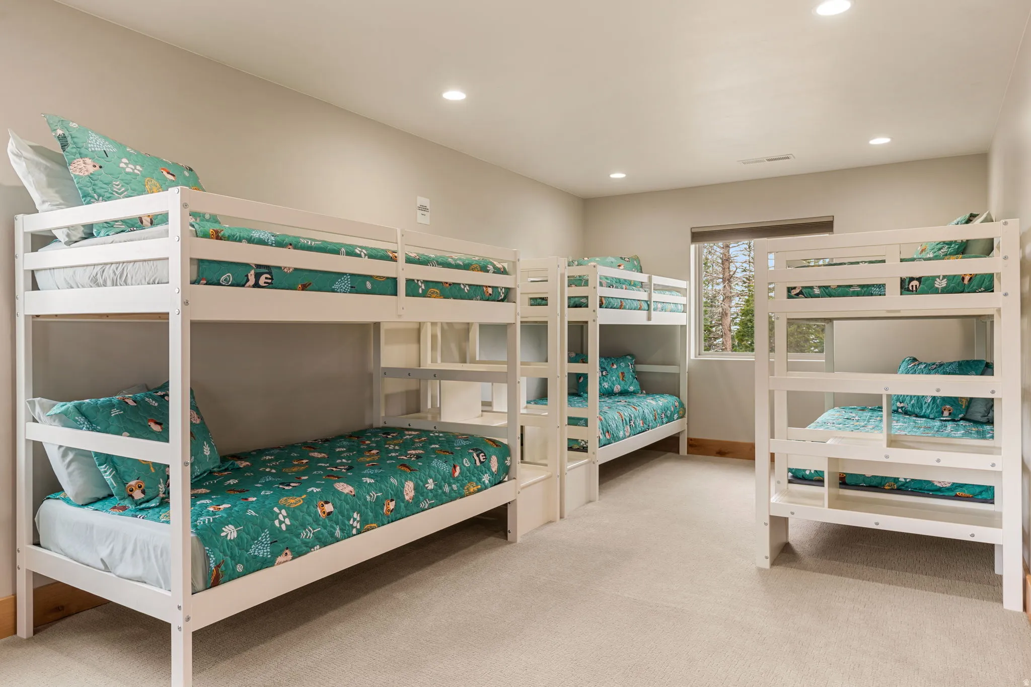 Spacious room with recessed lighting, light-toned walls, and a large window