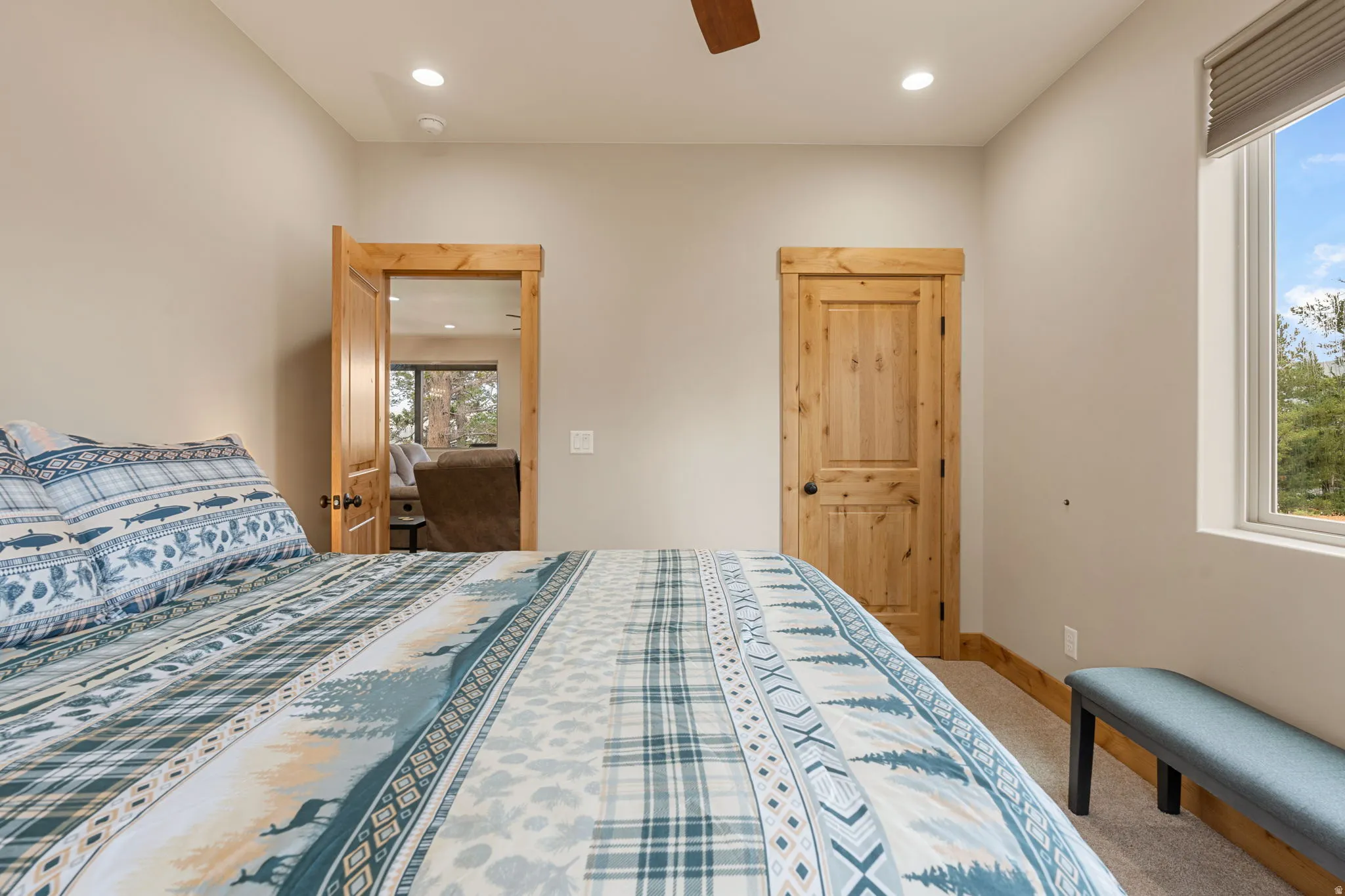 Recessed lighting, wood-finish doors, and a window with natural light