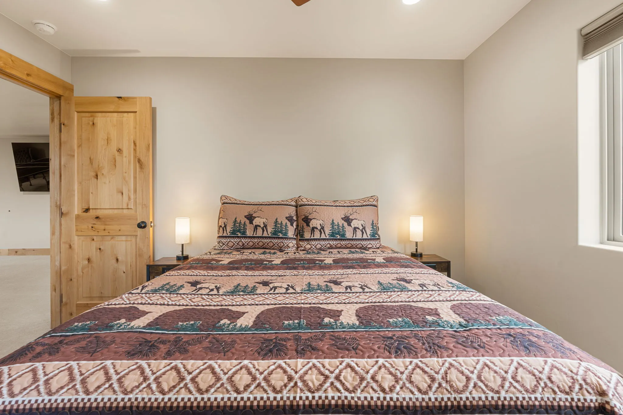 Recessed lighting, light-toned wall paint, wood-finish interior door, and window with blinds