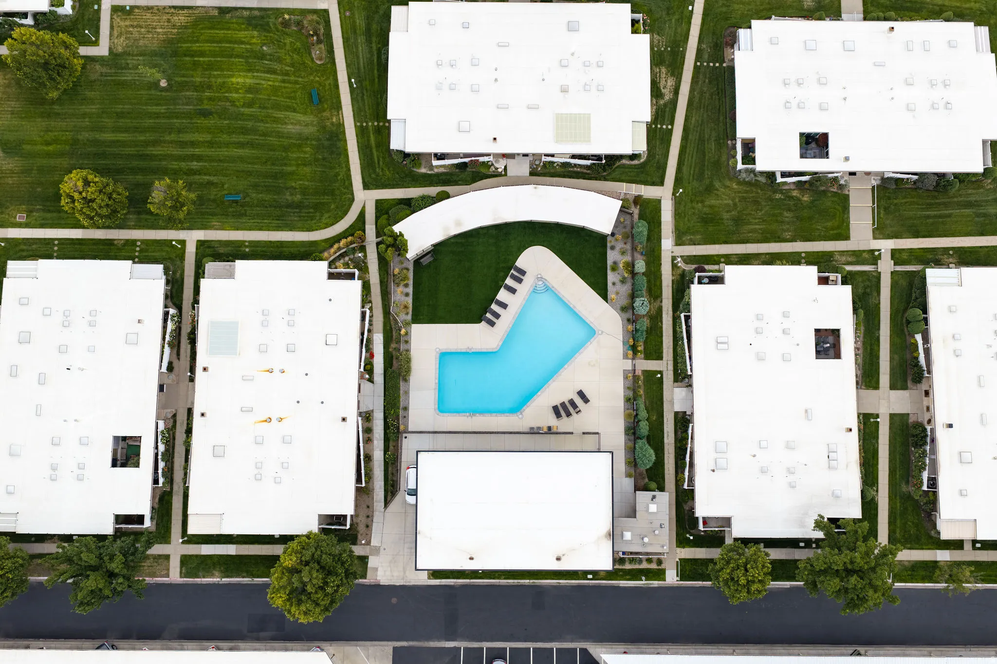 Community amenities include a swimming pool, multiple green spaces, and paved pedestrian pathways