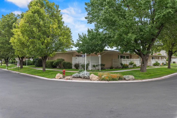 Landscaped grounds featuring mature trees, manicured lawns, and decorative rock gardens