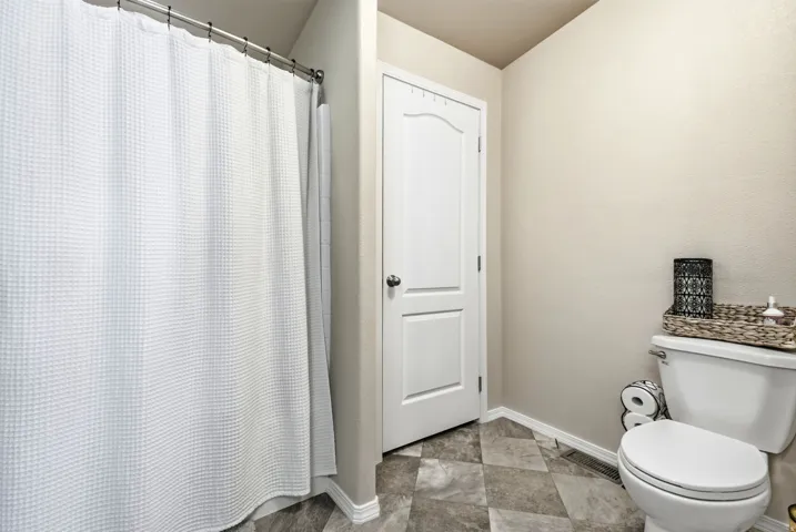 Neutral-toned walls complement the geometric tile flooring