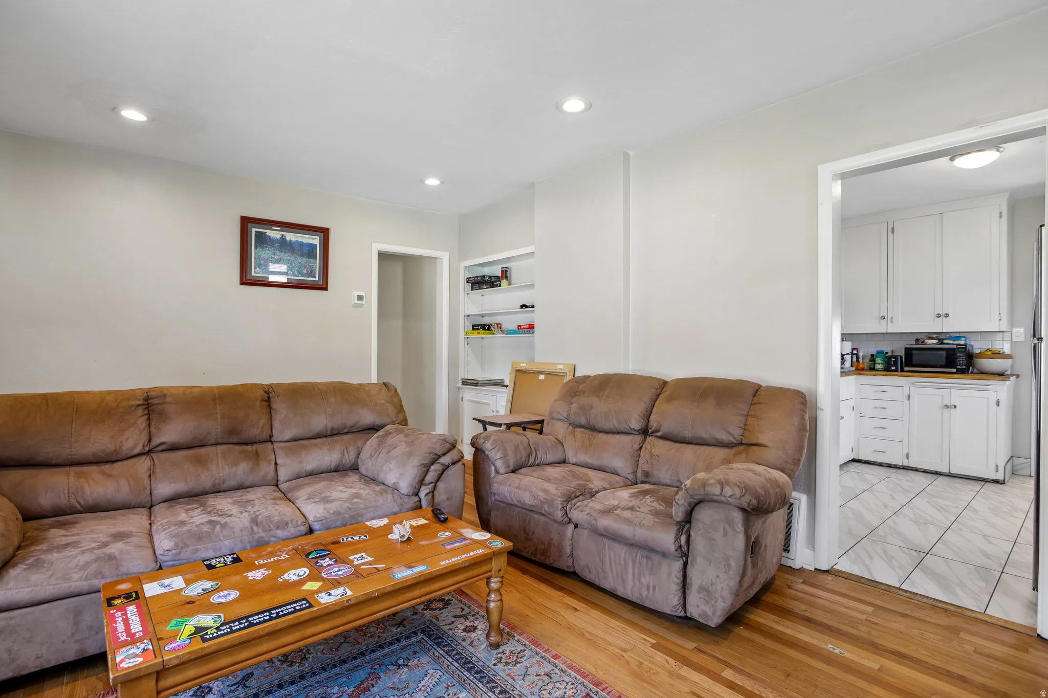 Hardwood flooring and recessed lighting in the living space