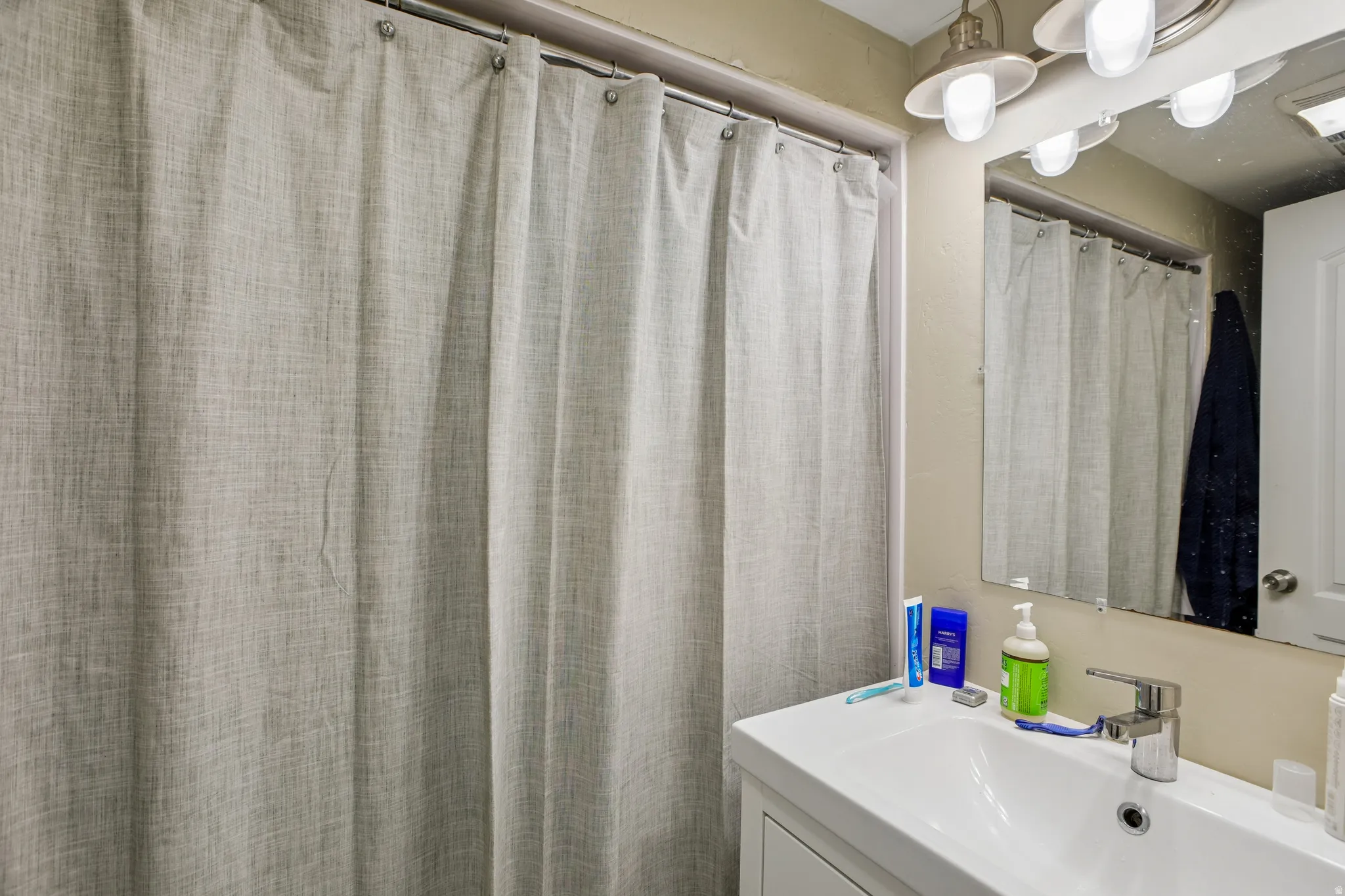 White vanity with an integrated sink and a chrome faucet