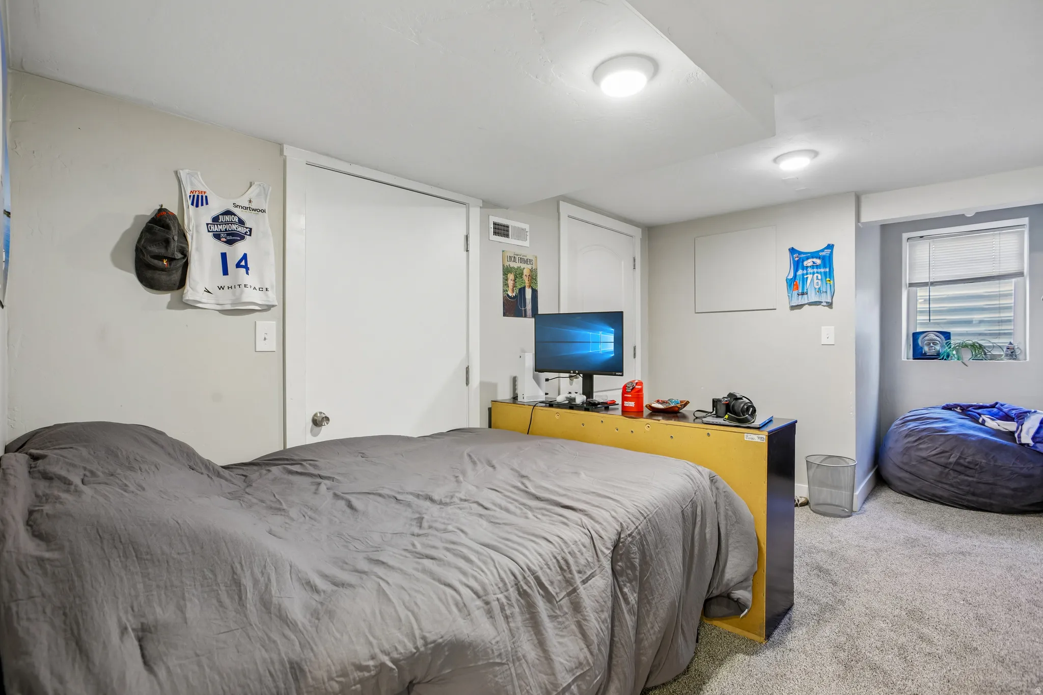 White painted doors, recessed lighting, and a single window with blinds