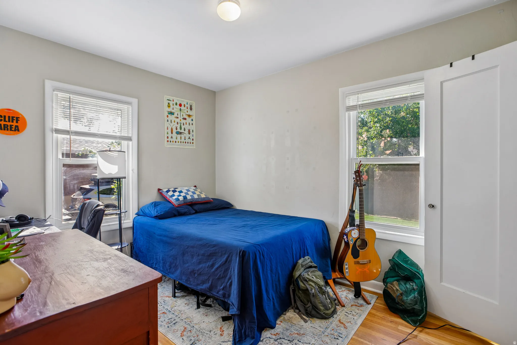 Hardwood flooring, painted walls, and window treatments