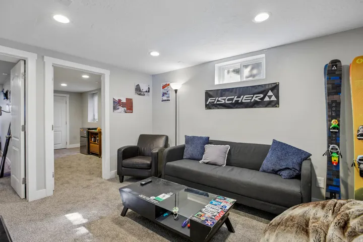 Recessed lighting illuminates a carpeted room featuring a transom window