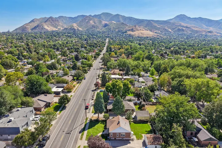 Neighborhood setting with established street, mature trees, and mountain backdrop