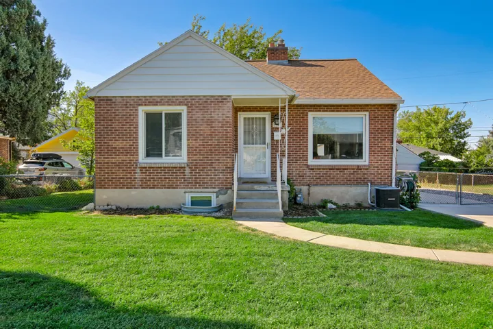 Brick exterior with white siding accents and a pitched shingle roof