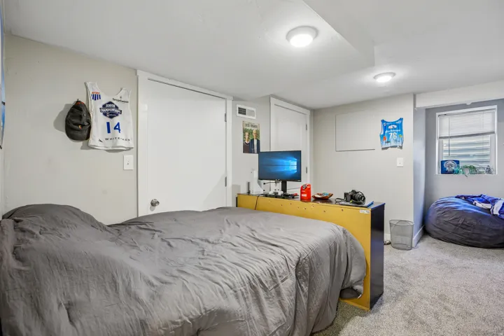 White painted doors, recessed lighting, and a single window with blinds