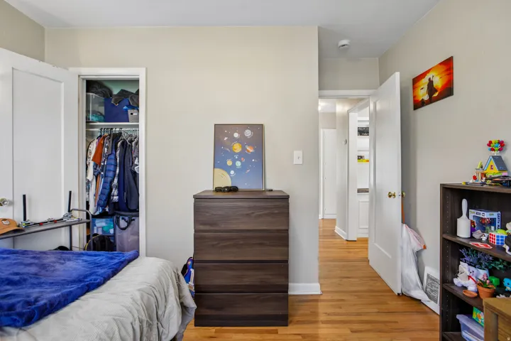 Hardwood flooring throughout the room and hallway