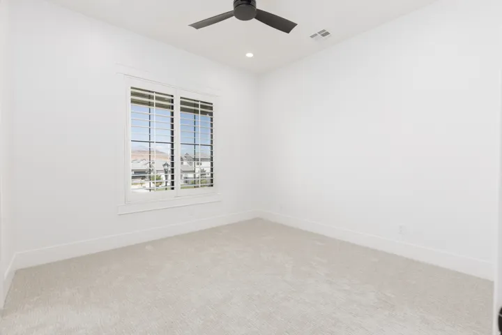Recessed lighting, ceiling fan, white window shutters, light-colored carpeting, and white walls